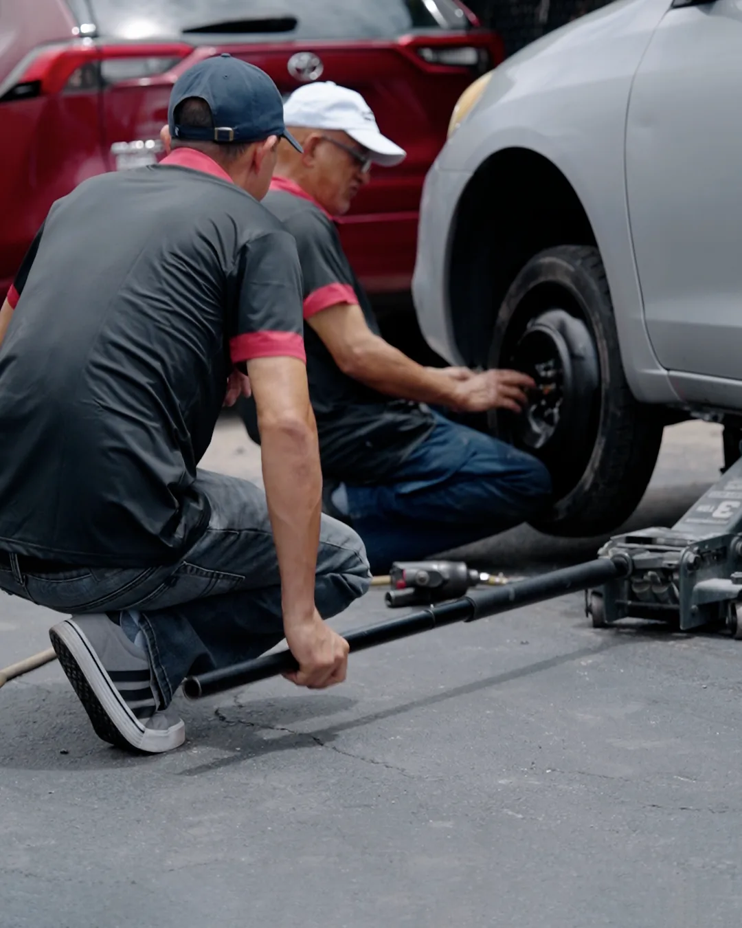 HA Collision Repair technicians changing a wheel at the roadside in Boca Raton